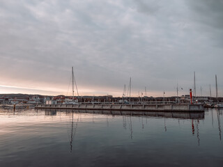 Pier in Sopot at sunrise time with amazing colorful sky. Many yachts and boats are moored at the pier. Poland. Europe. Vacation at sea. Selective focus. - obrazy, fototapety, plakaty