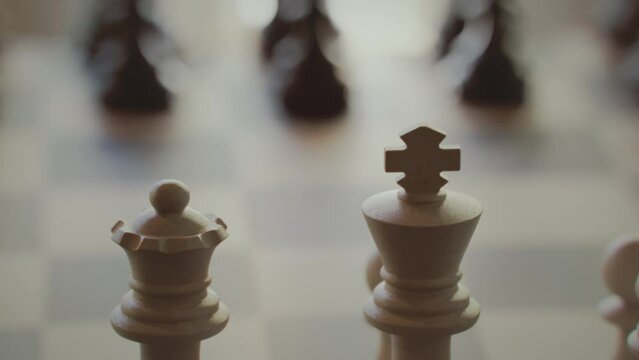 The game of chess. Close-up macro shot of chess pieces on the chessboard. Photorealistic studio shot 3d animation.