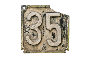 Old retro weathered cast iron plate with number 35 closeup isolated on white background