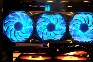Close-up triple cooling fans on industrial high performance computer graphic card on standby mode...