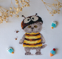 Cross-stitch cat in a bee costume