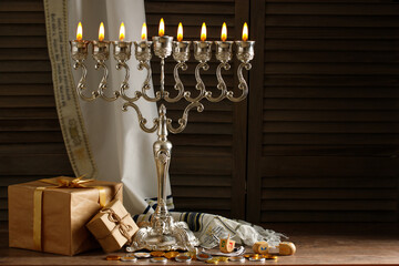 Jewish religious holiday Hanukkah with holiday Hanukkah (traditional candelabra), tallit, gift...