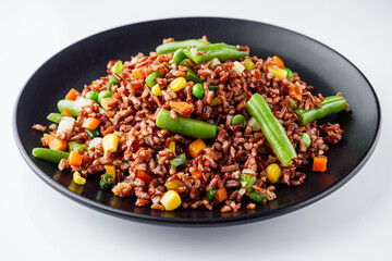 delicious red rice with vegetables on a white background