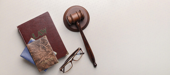 Judge's gavel, book and passports on light background with space for text. Immigration law concept