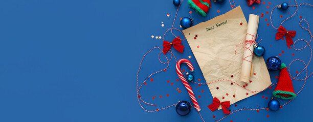 Composition with blank letter to Santa and Christmas decorations on blue background with space for...