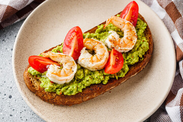 delicious Italian bruschetta with shrimps on a gray stone background