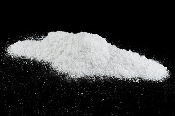 Pile of white snow isolated on a black background. Snow crystals. Snowdrift.