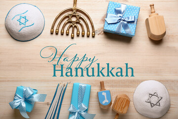 Gifts, menorah, candles, Jewish hats and dreidels for Hannukah celebration on wooden background