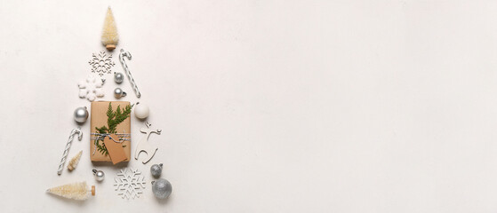 Christmas tree made of gift box and beautiful decorations on light background with space for text