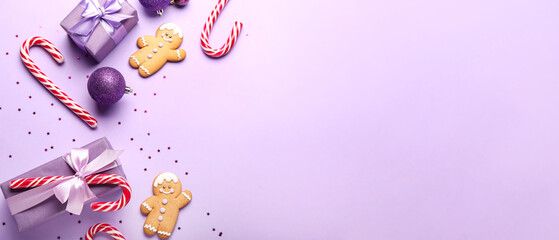 Candy canes with Christmas gifts and cookies on lilac background with space for text