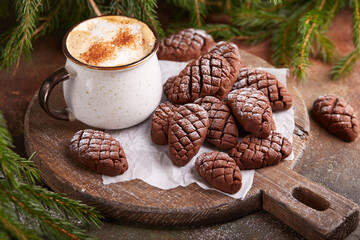 Cookies in a shape of Christmas tree cones with chocolate. Delicious New Year homemade dessert.