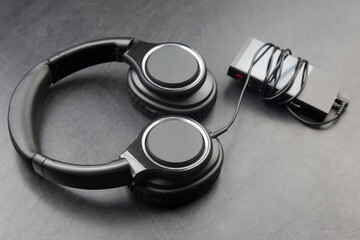Headphones for listening to music with digital audio player on dark background