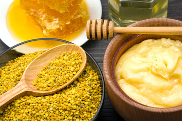 Fresh flower honey of different varieties, pollen and honeycomb with spoons on a wooden background. Organic Vitamin Health Food