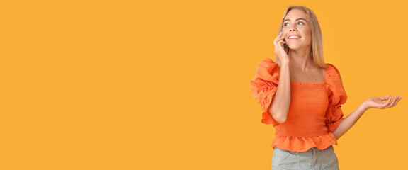 Teenage girl talking by mobile phone on orange background with space for text