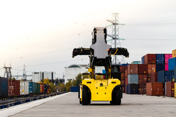 Forklift handling cargo container. Freight container loading. Container handler.  Logistics import export concept. Industrial container logistic yard.