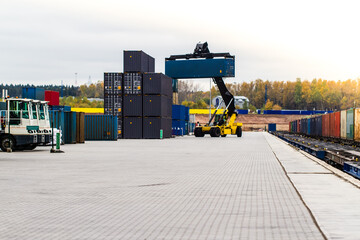 Forklift handling cargo container. Freight container loading. Container handler.  Logistics import export concept. Industrial container logistic yard.