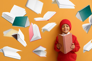 Little African-American boy and many flying books on orange background