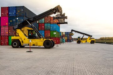 Forklift handling cargo container. Freight container loading. Container handler.  Logistics import export concept. Industrial container logistic yard.
