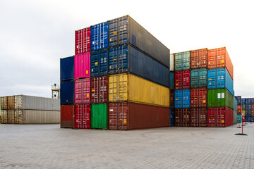 Fototapeta premium Cargo containers. Cargo container yard. Stack of freight containers at the docks. Industrial yard. Import and export logistic concept.