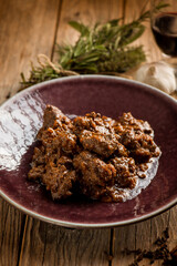 venison stew traditional italian recipe and glass of red wine