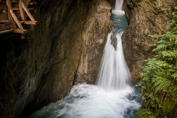 The beautiful view of Sigmund Thun Gorge - Sigmund Thun Klamm. Cascade valley of wild Kapruner Ache near Kaprun, Austria. Crystal clear blue water. Wooden hike trail path. 4K background, HD wallpaper.