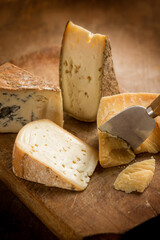 variety of traditional italian cheese over cutting board