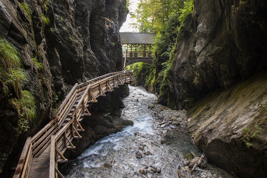 The beautiful view of Sigmund Thun Gorge - Sigmund Thun Klamm. Cascade valley of wild Kapruner Ache near Kaprun, Austria. Crystal clear blue water. Wooden hike trail path. 4K background, HD wallpaper.