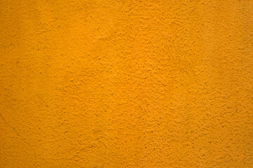 Orange Abstract Background. Painted Orange Color Stucco Wall Texture With Copy Space. Bright Art Wallpaper. Abstract grunge surface orange gold background golden yellow highlights