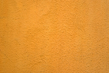 Fototapeta premium Orange Abstract Background. Painted Orange Color Stucco Wall Texture With Copy Space. Bright Art Wallpaper. Abstract grunge surface orange gold background golden yellow highlights