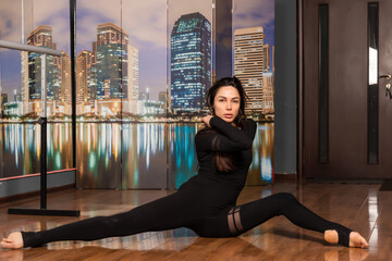 Girl in black dress are training in dance studio