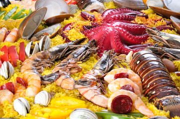 Traditional seafood paella with octopus, lobster, rice and shellfish