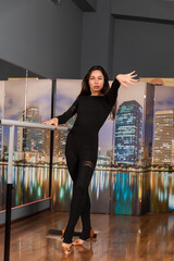 Girl in black dress are training in dance studio