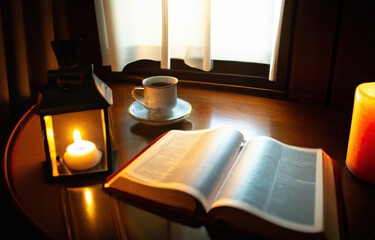 An open bible with coffee cup for morning devotion on wooden table with window light.