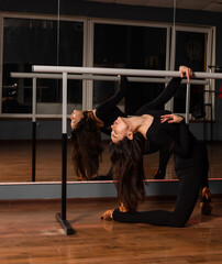 Girl in black dress are training in dance studio