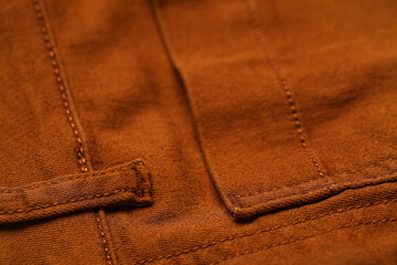 Closeup view of brown pants with pocket