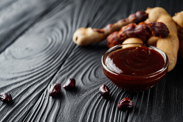 sweet and sour tamarind sauce on a black rustic wooden background