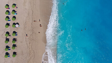 Aerial drone top down photo of paradise organised sandy - crystal clear turquoise sea beach in exotic island destination