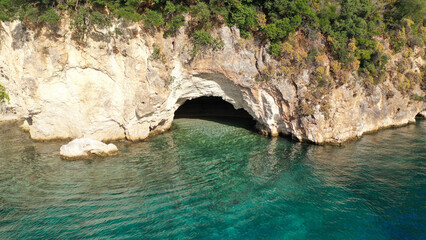 Fototapeta na wymiar Aerial drone photo of famous small bay and beach with crystal clear sea and caves of Desimi near Nidri in island of Lefkada, Ionian, Greece