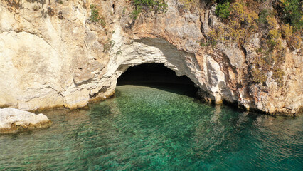Fototapeta premium Aerial drone photo of famous small bay and beach with crystal clear sea and caves of Desimi near Nidri in island of Lefkada, Ionian, Greece