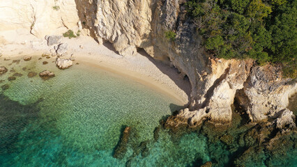 Aerial drone photo of famous small bay and beach with crystal clear sea and caves of Desimi near Nidri in island of Lefkada, Ionian, Greece