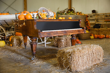 Grand piano with pumpkins and glowing lights at fall fair