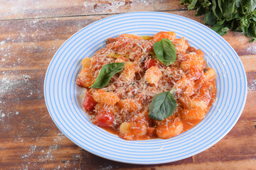pasta in red sauce with parmesan cheese, tomato, basil, herbs, delicious food from Italian and French cuisine