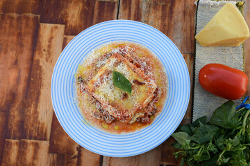 lasagna white and bolognese sauce with parmesan cheese, pasta, tomato, basil, herbs, delicious food from Italian and French cuisine