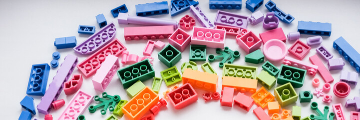 Many toy blocks in different colors, top view. Toys and games.Set of colorful educational toddler toys onwhite background. Education,montessori, building blocks construction. web banner