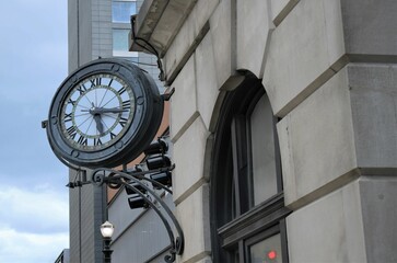 Fototapeta na wymiar Vintage clock on building in urban area