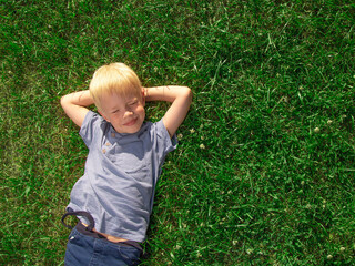 A boy lying on the grass