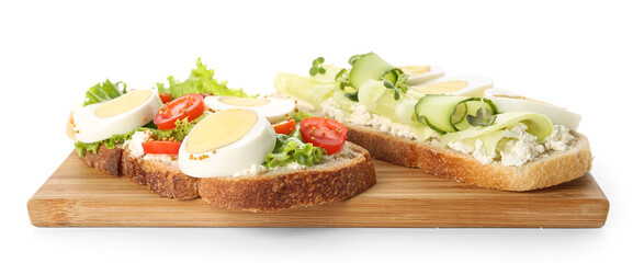 Wooden board of tasty toasts with boiled egg, cucumber and tomatoes on white background