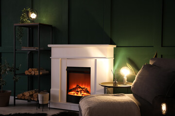 Interior of dark living room with fireplace, glowing lamps and shelving unit