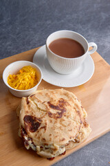 Salvadoran national dish pupusas stacked and served with curtido and hot chocolate