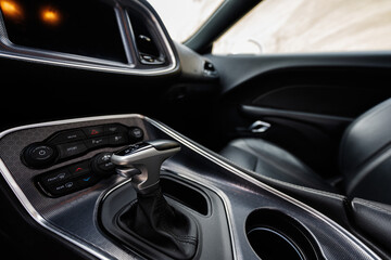 Interior of the muscle car. Close up of the automatic gearbox lever,  Automatic transmission gearshift stick.